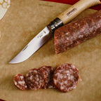Cuchillo Opinel N°10 Stainless Steel - vista 6, cortando cecina, en uso, imagen de estilo de vida
